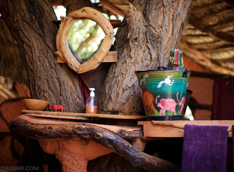 Elephant Watch Camp, en suite bathroom built into the trees that the camp is built on top of, including a mirror inbetween two tree branches, Kenya