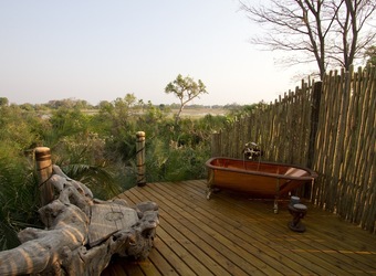 Jacana Camp, outdoor bathroom with soaking tub open to nature, secluded wooden deck with views of savanna, fenced in area, quiet solitude
