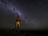 Khalahari Plains Camp, spectacular stars, local African native in traditional dress with a handmade bow and arrow, milky way, Botswana, Africa