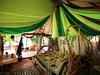 Elephant Watch Camp, a bedroom with a bed made from the curved branches of trees enclosed by a canopy filled with a variety of green shades, Kenya