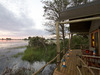 Jacana Camp, edge of deck with panoramic views of Okavango Delta at sunset, enclosing railing, wooden deck, luxury accomodations, Africa, Botswana 