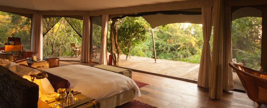 Beautiful expansive bedroom on African safari, Mara Plains Camp, 360 degree open air views of the surrounding wilderness, wonderful old copper bathtub